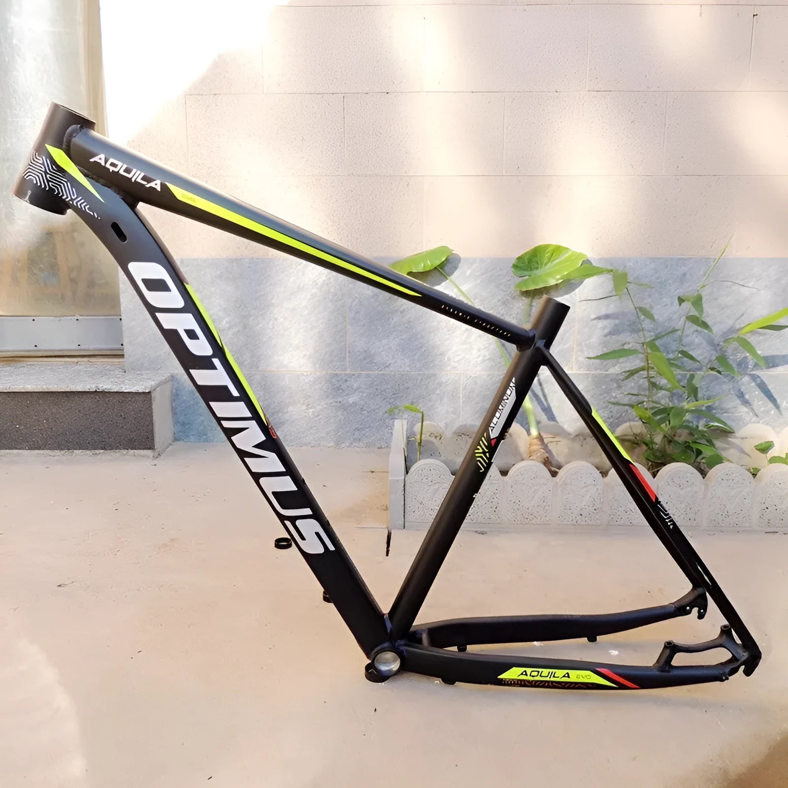 Black green aluminium mountain bike frame for 29-inch wheels with internal cable routing and disc brake mounts.