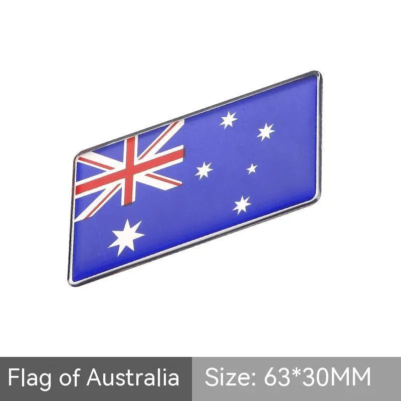 Aluminium national flag car sticker in a parallelogram shape measuring 6.3 by 3 centimetres.