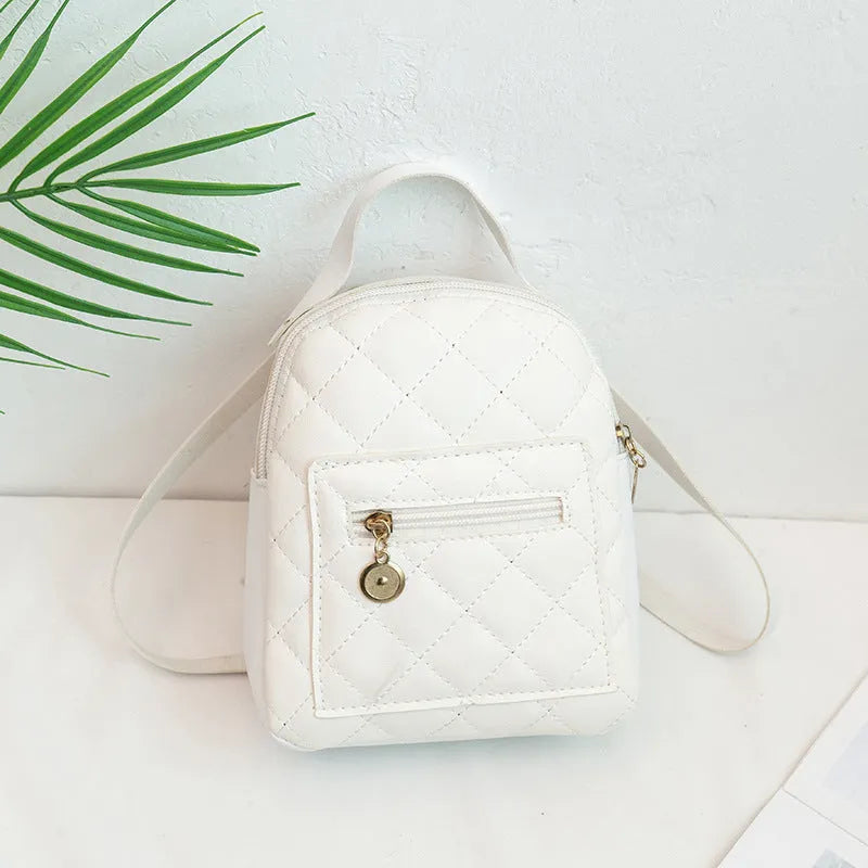 Girls square hard PU backpack with embroidery detail in black, pink or white, showing soft handle and outer pocket.