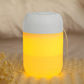 White cylindrical USB-powered mini humidifier with aromatherapy function on a wooden desk.