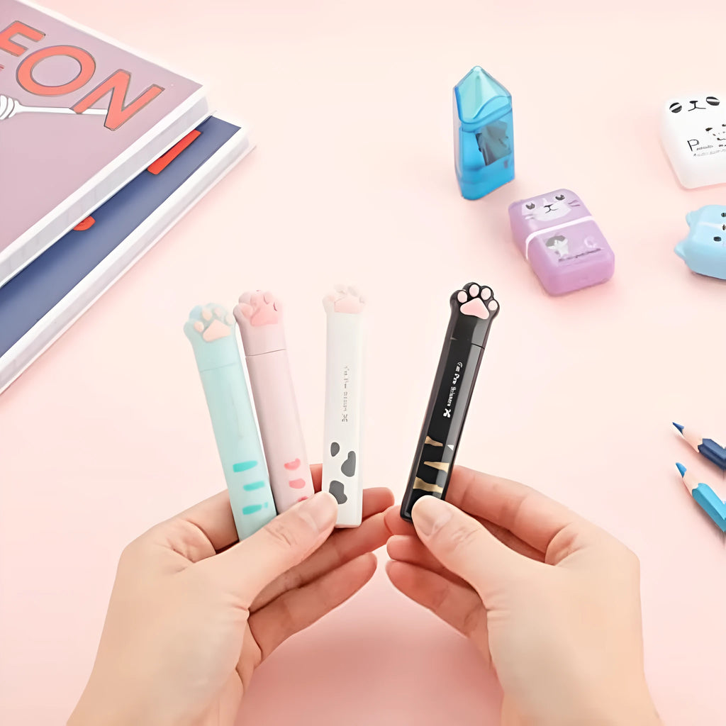 Mini folding scissors with cat paw design on handle, shown in pink, white, black, and blue colour options.