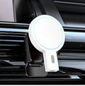 White and black magnetic wireless charger on a desk with a mobile phone