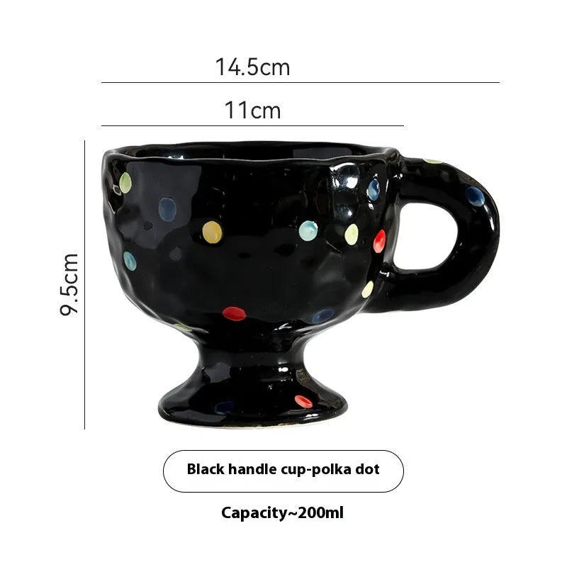 Hand-pinched irregular shaped solid colour ceramic mug on a table, showing its unique form and modern simplicity design.
