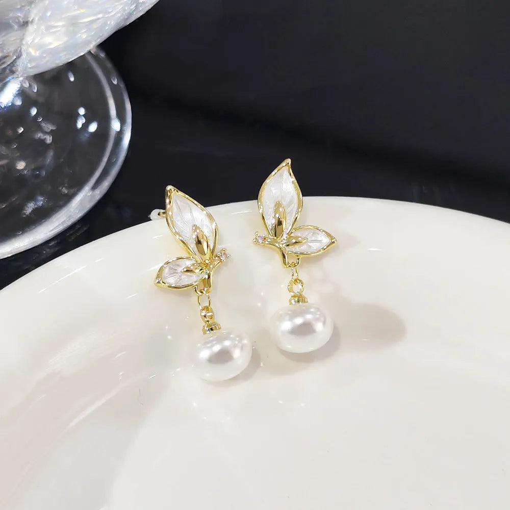 Close-up of a pair of zircon painting oil finish butterfly stud earrings on a copper base, style PT0203.
