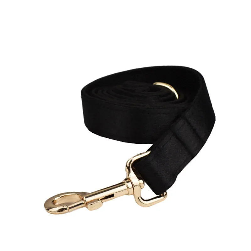 Cloth dog collar, leash, harness vest, and decorative bow set shown together in packaging.