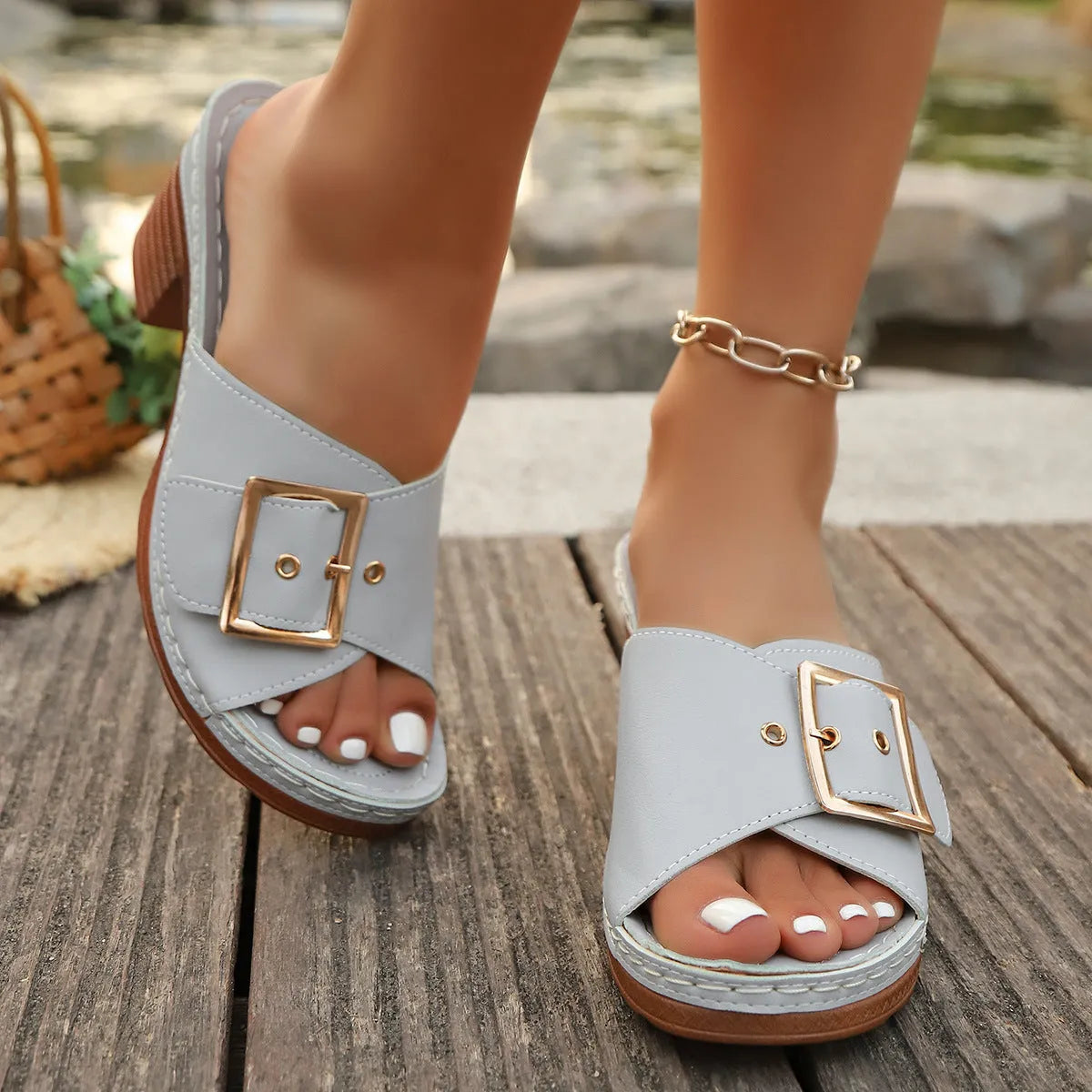 Women's retro style slippers with chunky heel and metal buckle detail in light blue colour