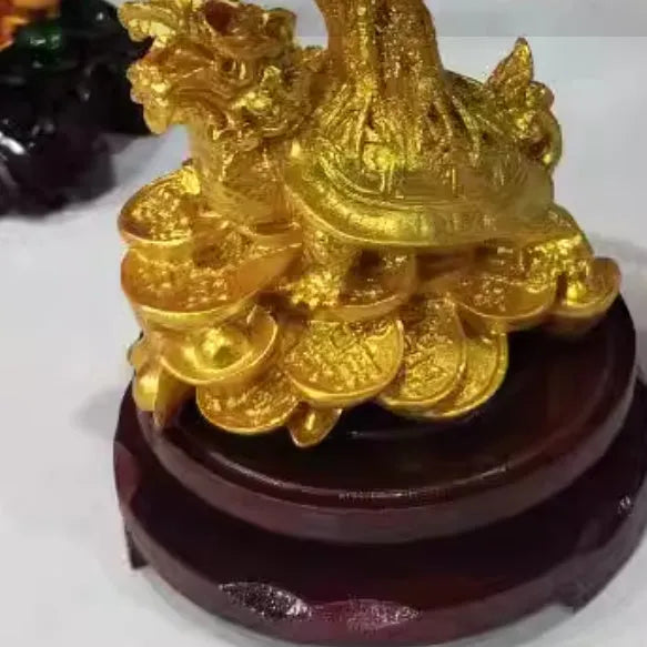 Citrine-coloured resin money tree ornament with a small turtle, measuring 18 by 23 cm.