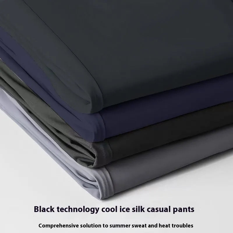 Man wearing black Ice Silk straight loose fit casual trousers with an elastic waistband.