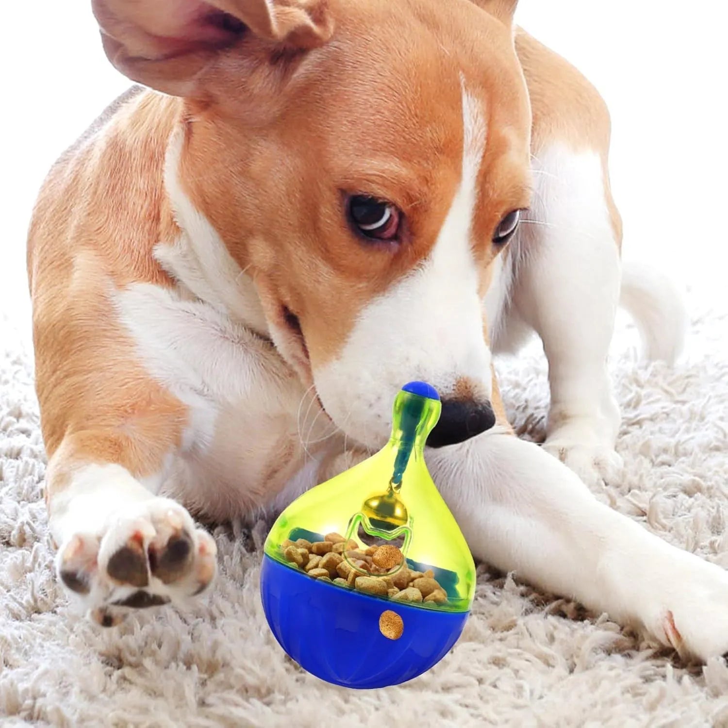 Grey tumbler-shaped interactive pet treat dispenser ball on a wooden floor.