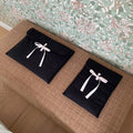 Women's black and white striped quilted computer bag with ballet style bow detail