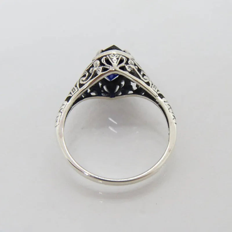 Silver women's ring with geometric hollow pattern in alloy metal showing side profile view