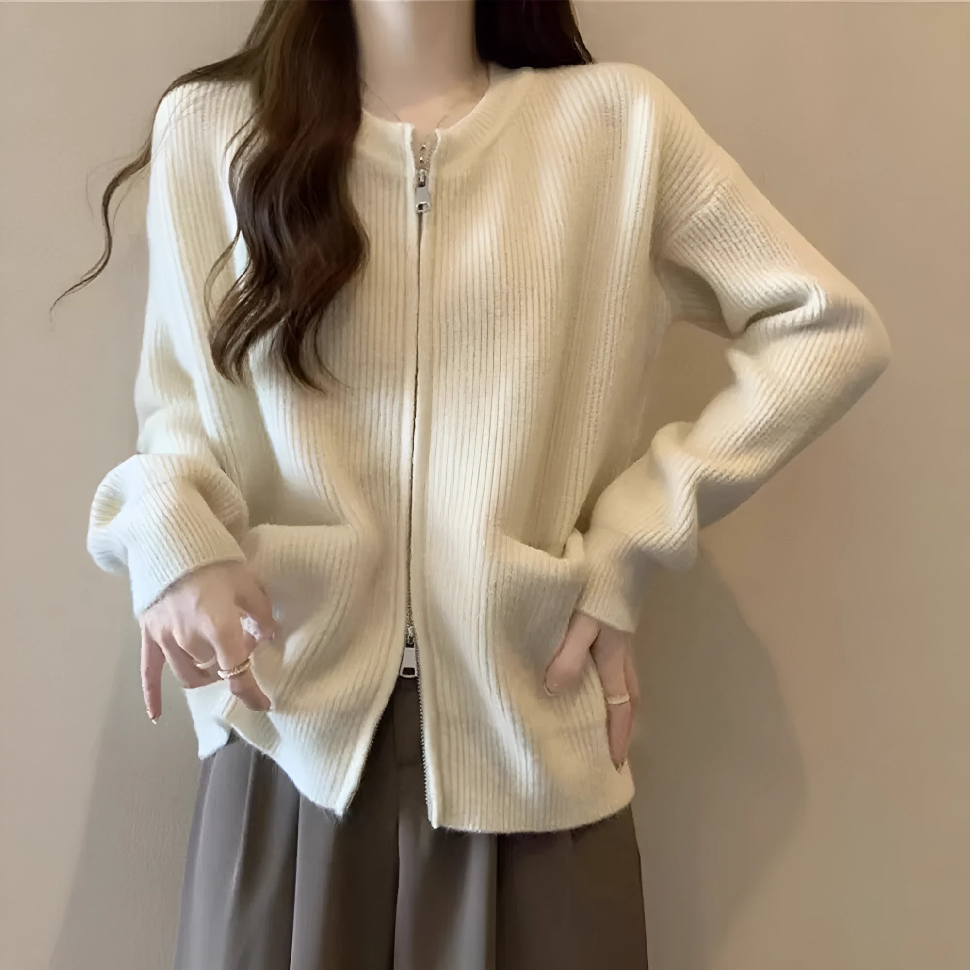 Beige soft viscose women's sweater coat cardigan with long sleeves on a hanger.