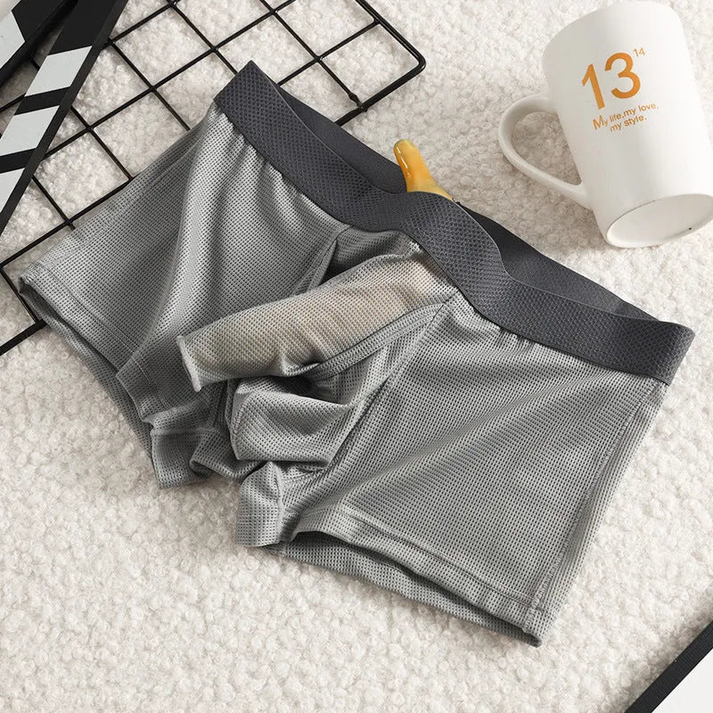Solid colour men's ice silk boxer shorts with a low waist and knitted mesh fabric.