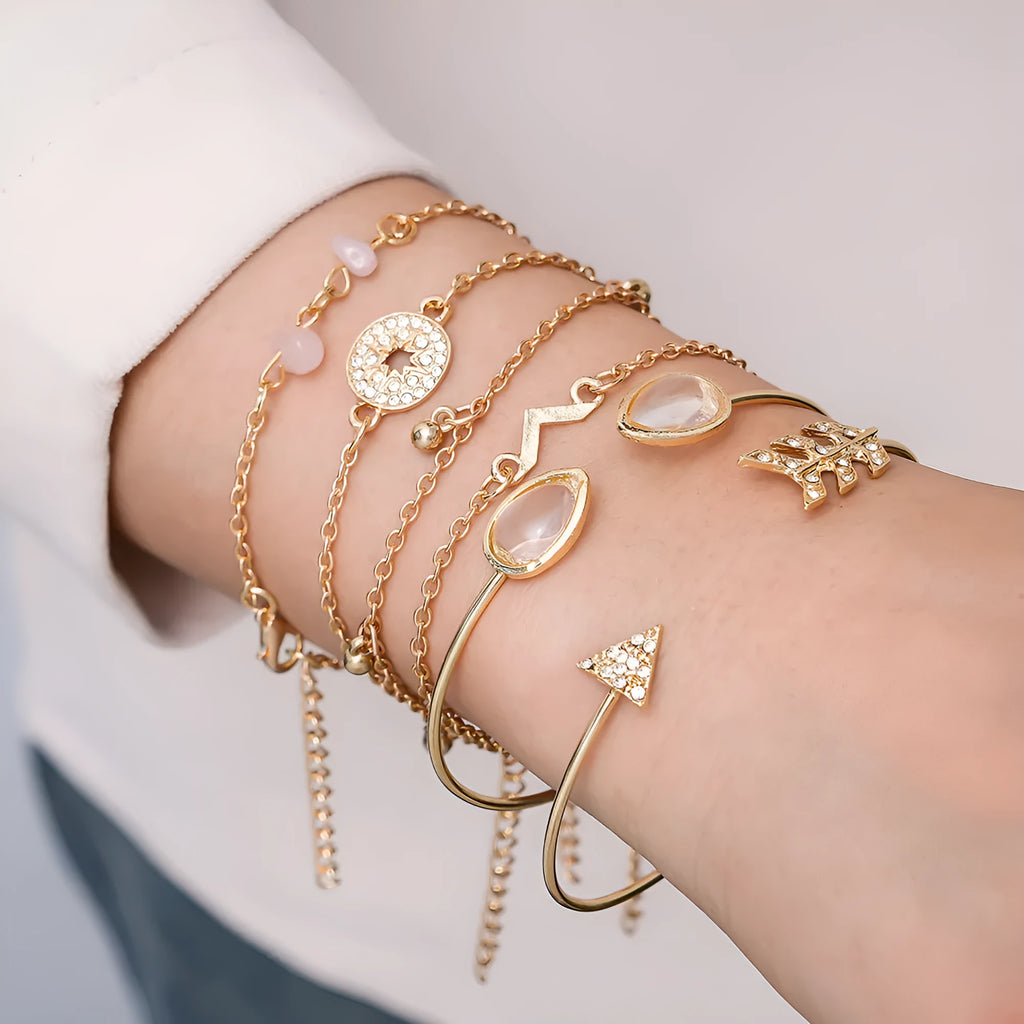 Gold-coloured six-piece bracelet set with arrow and water drop shapes featuring spot drill detailing