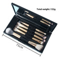 Makeup brush set with mirror showing silver or gold finished brushes with artificial fibre bristles