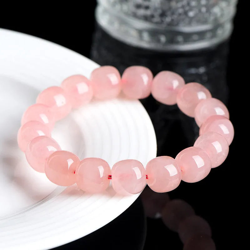Natural crystal barrel shaped bead bracelet with pink polished geometric beads
