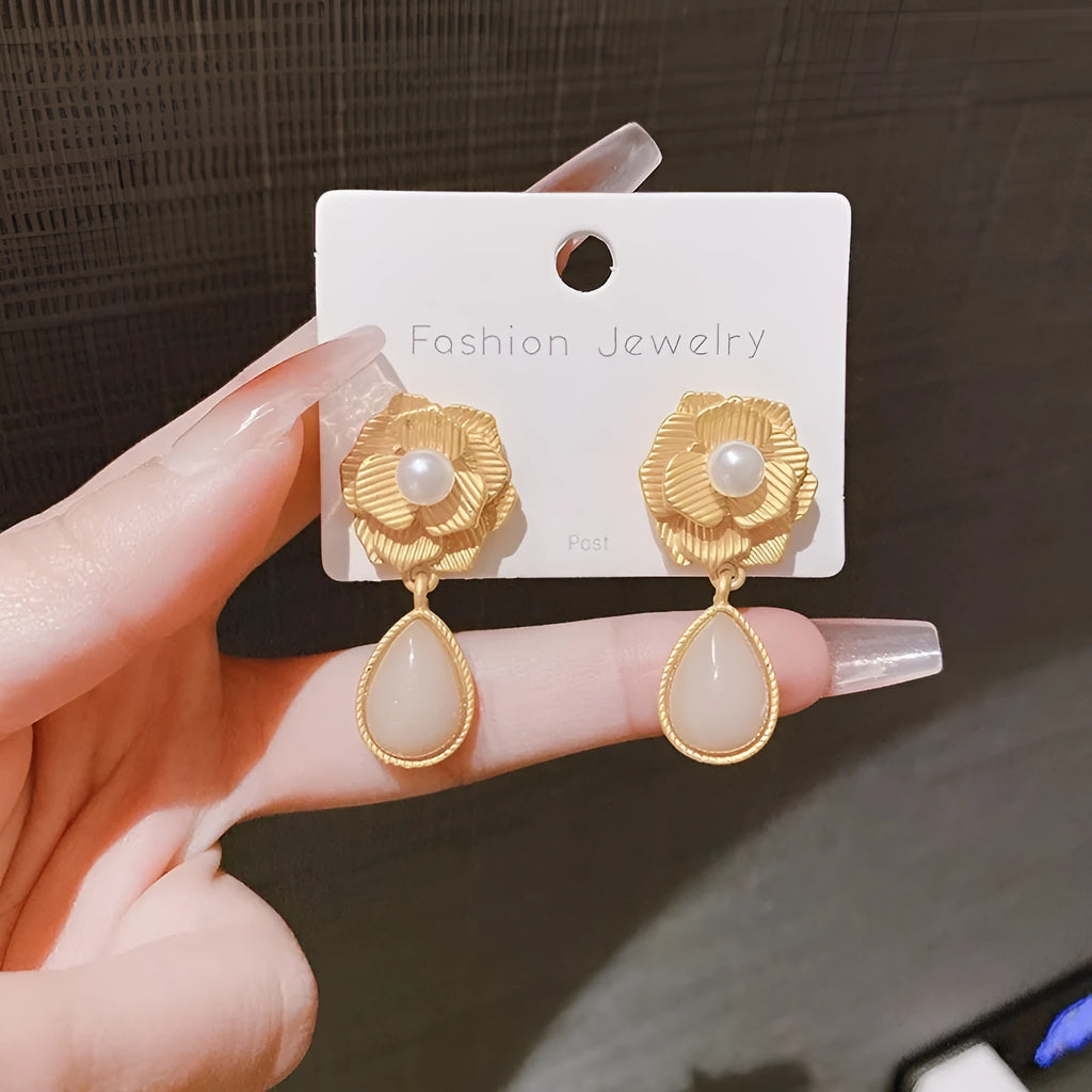 Gold-coloured floral stud earrings with a detailed needle rose pearl and opal stone design.