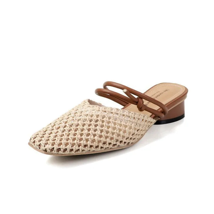 Women's black square toe slippers with hollow-out design and a chunky heel on a rubber sole.