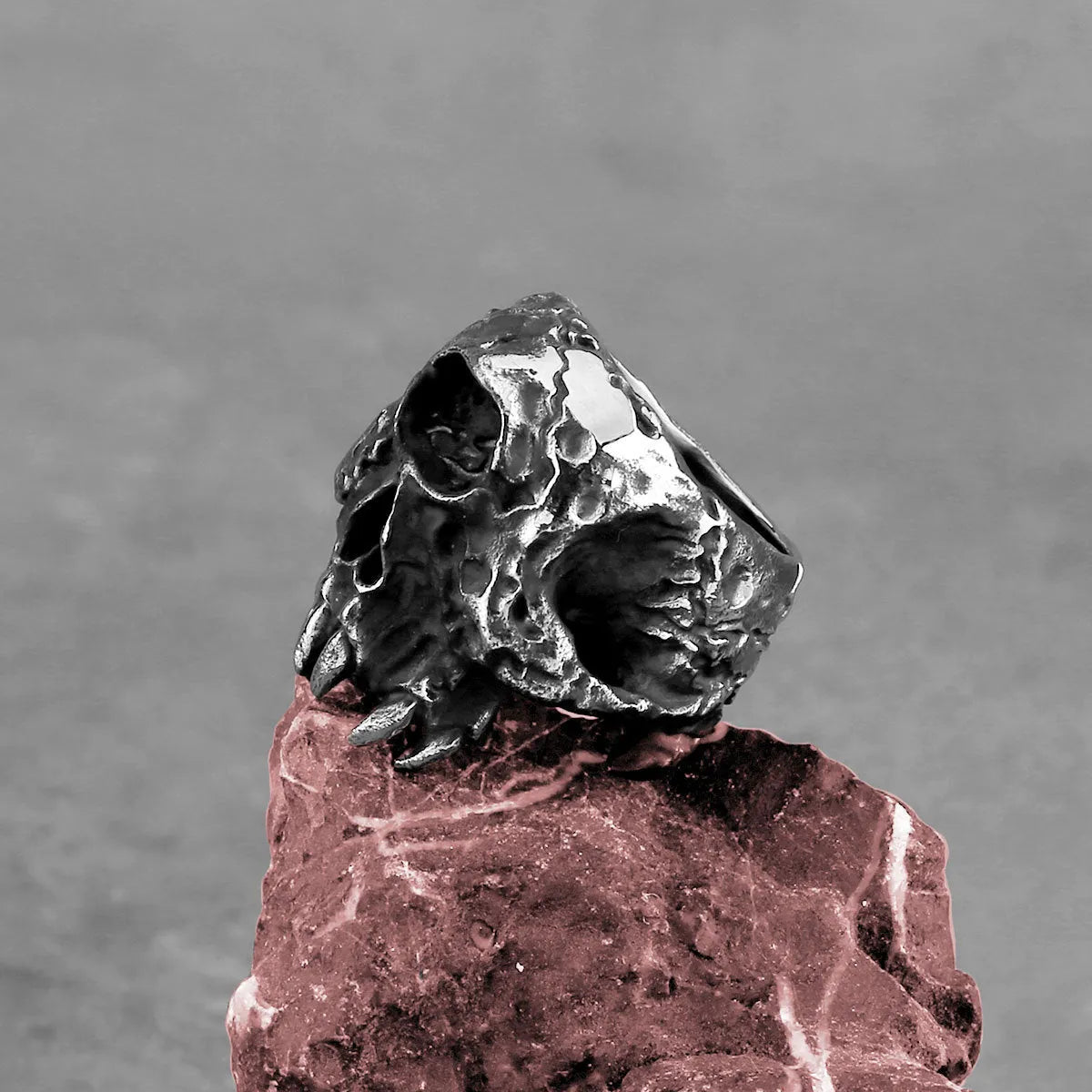 Alloy skull ring with one-eyed design in silver electroplated finish shown on finger
