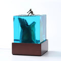Ocean shark surfer micro landscape night light made of clear epoxy resin on a plastic stand