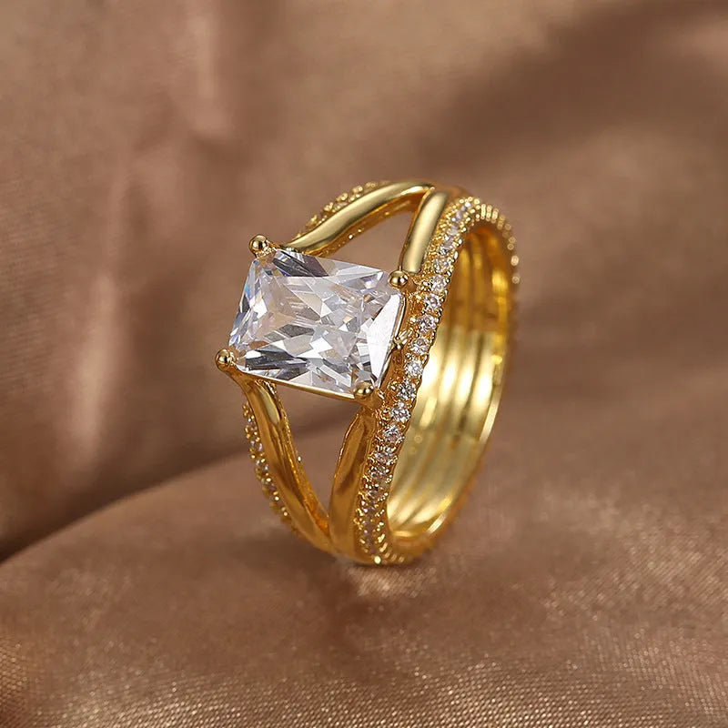 Gold coloured geometric women's ring with square zircon detailing on copper with electroplated finish