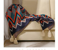 Bohemian-style acrylic sofa cover blanket with tassel trim in a geometric pattern colour option