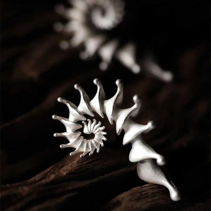 Matte finish conch stud earrings with three-dimensional shaping and irregular design elements