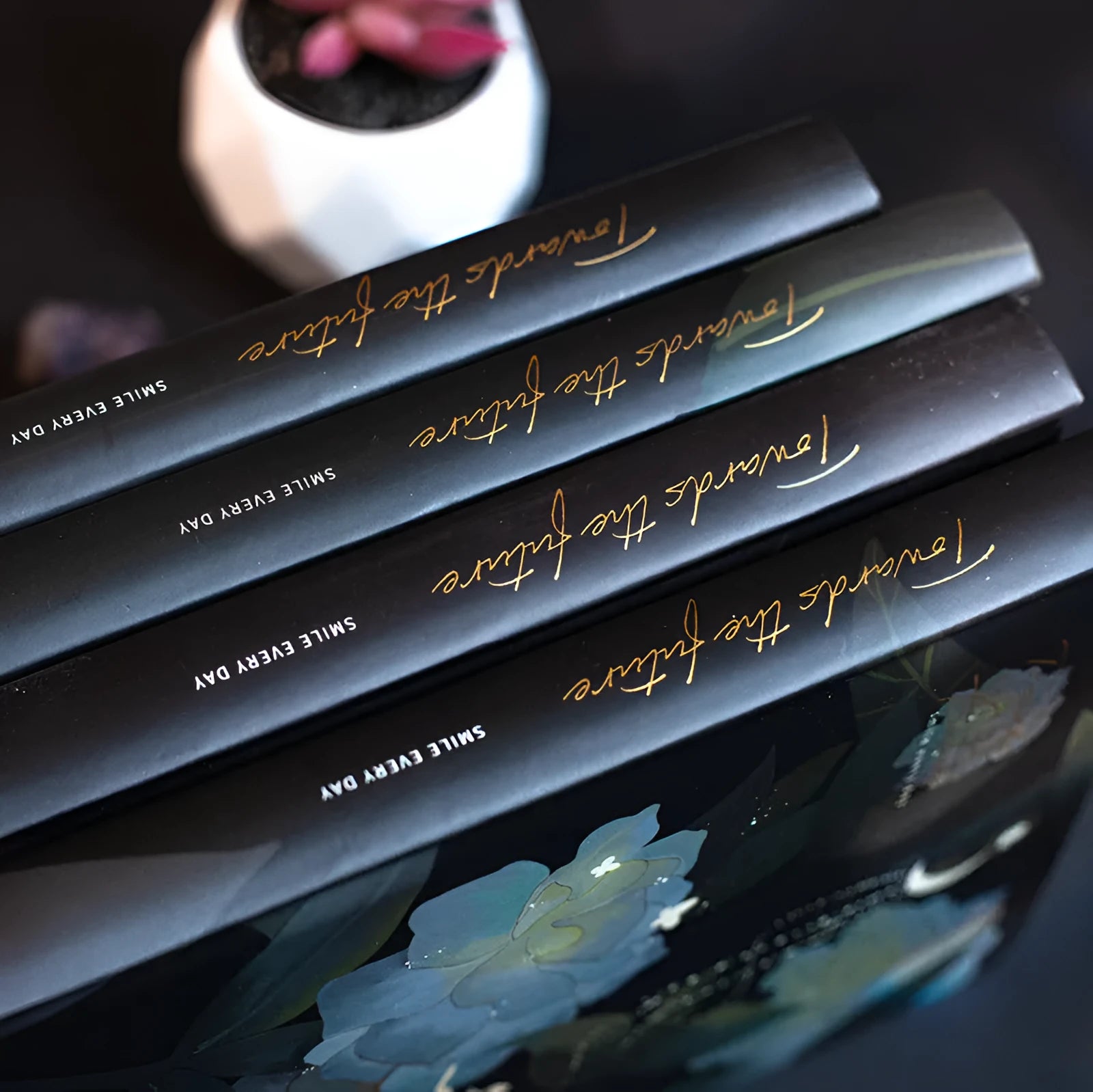 A5 diary notebook with luminous holographic cover open to show pages with colour illustrations.