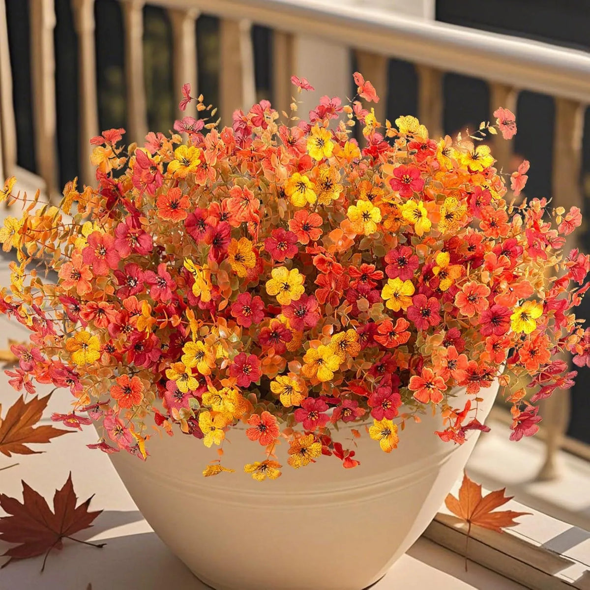 Artificial silk and plastic flower bouquet in autumn colours of red, yellow, and orange for home or wedding decoration