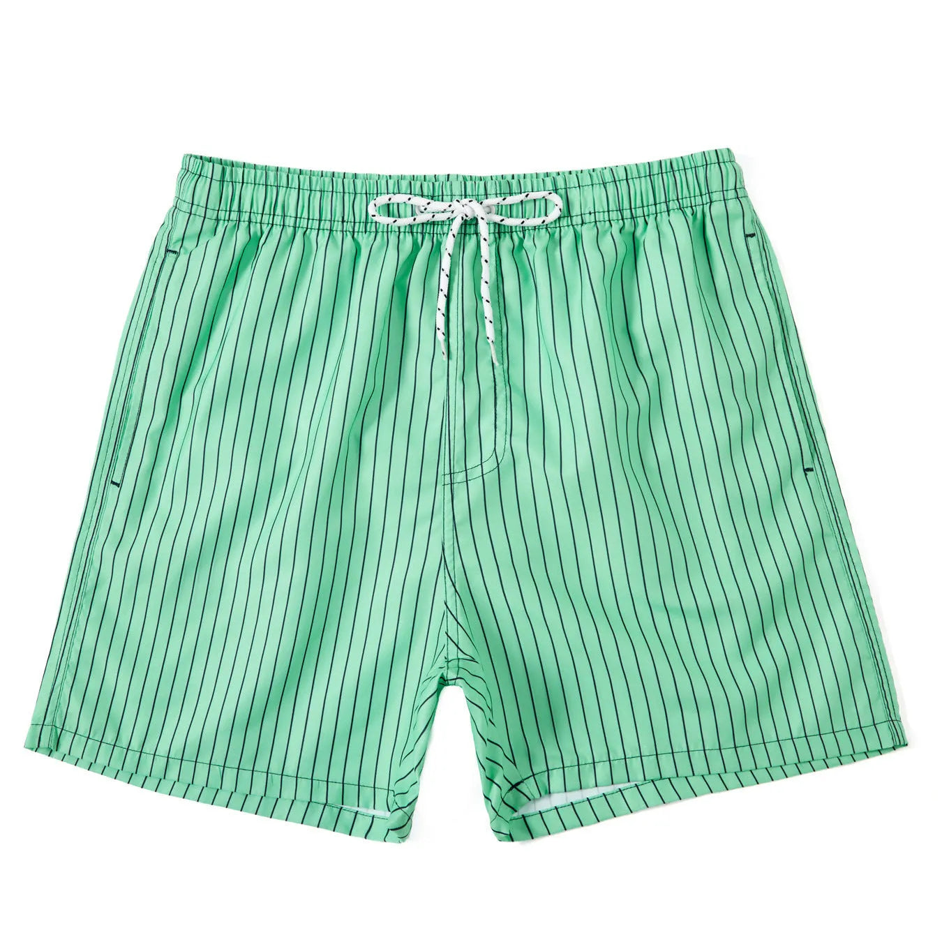 A man wearing grey striped polyester beach shorts with a straight leg opening, shown on a beach.