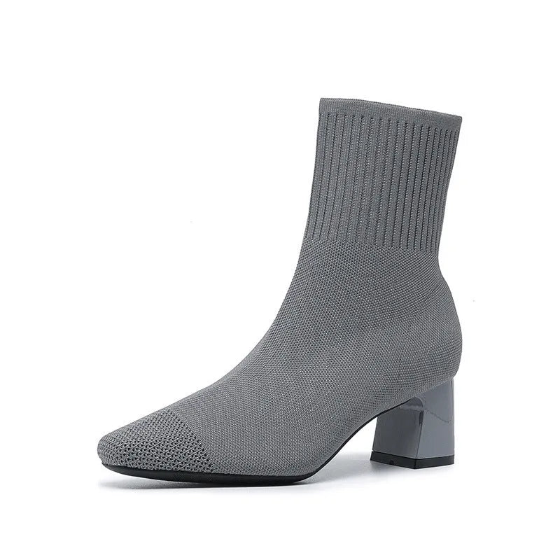 Women's knitted sock boots with chunky high heel and square toe, mid-calf length, shown in black