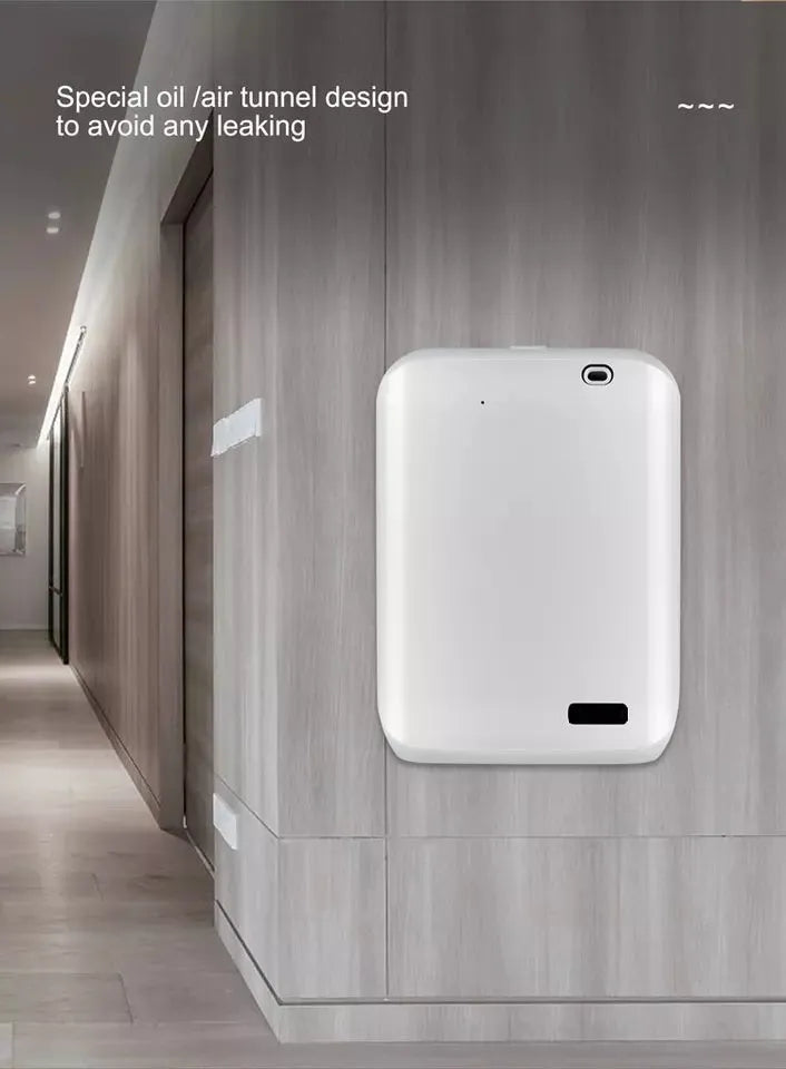 White wall-mounted smart aroma diffuser with 150ml tank and app control on a grey wall.