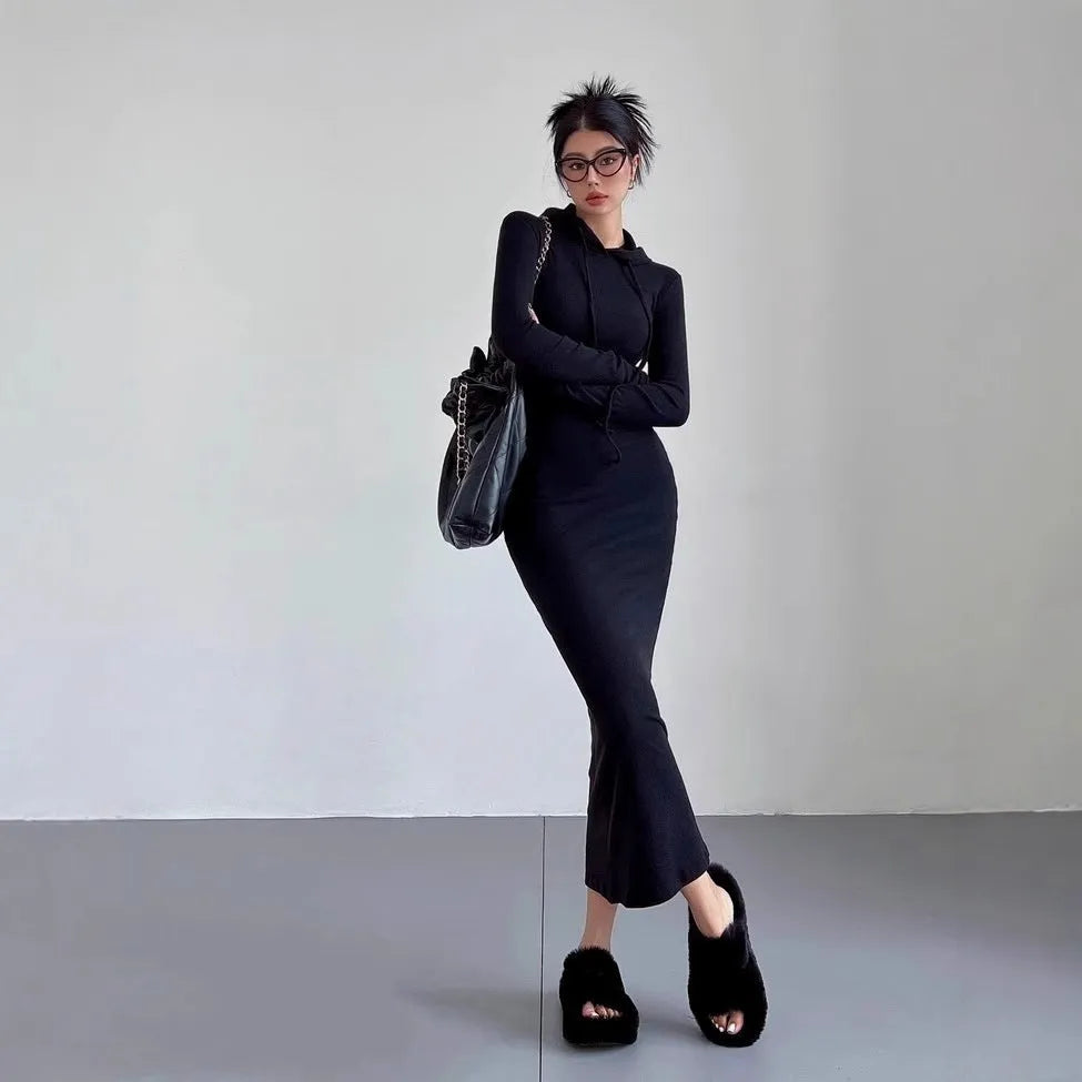 A woman's long sleeve hooded sheath dress in polyester, showing the high waist and over-the-knee length.