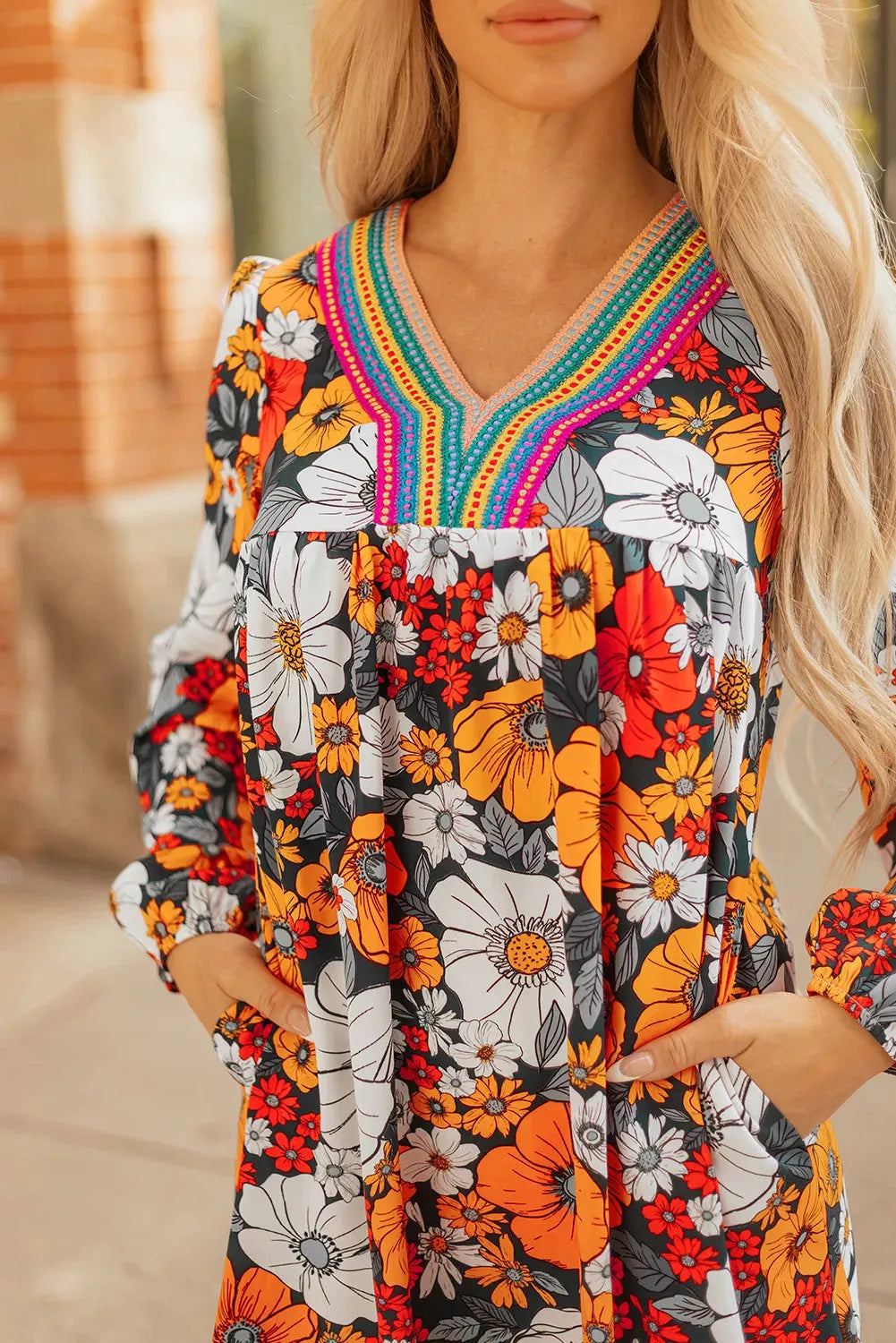 Orange floral print women's mini dress with V-neck, long sleeves, and lace trim
