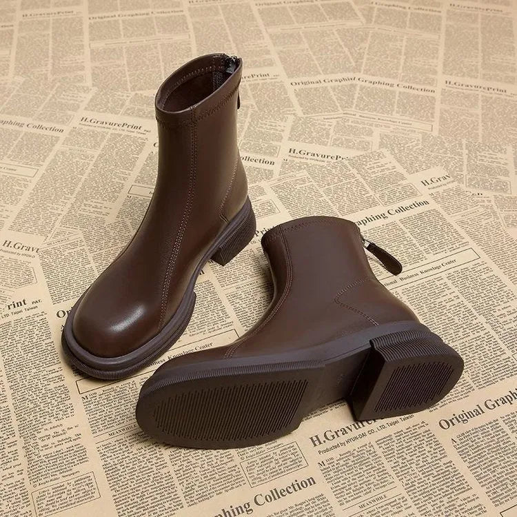 Women's black flat heel ankle boots with round toe and back zipper closure