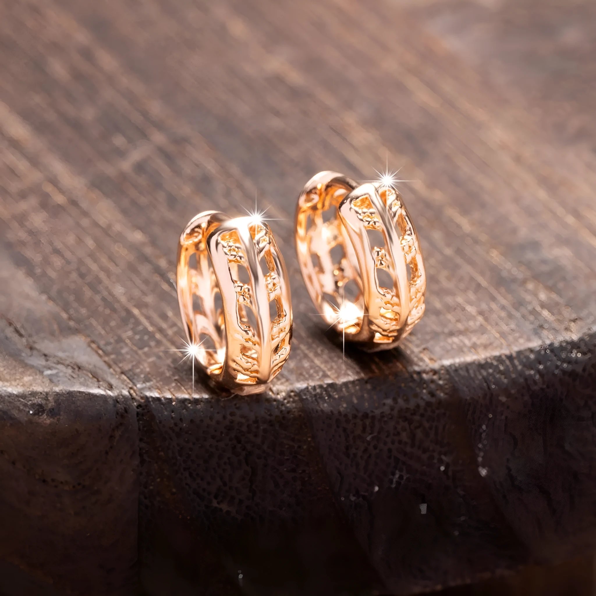 Rose gold coloured hollowed out copper earrings featuring a leaf and heart shape design.