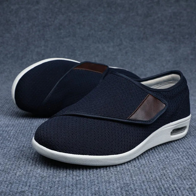 Beige wide-fit leisure shoes with velcro strap and rubber foam sole on a neutral background.