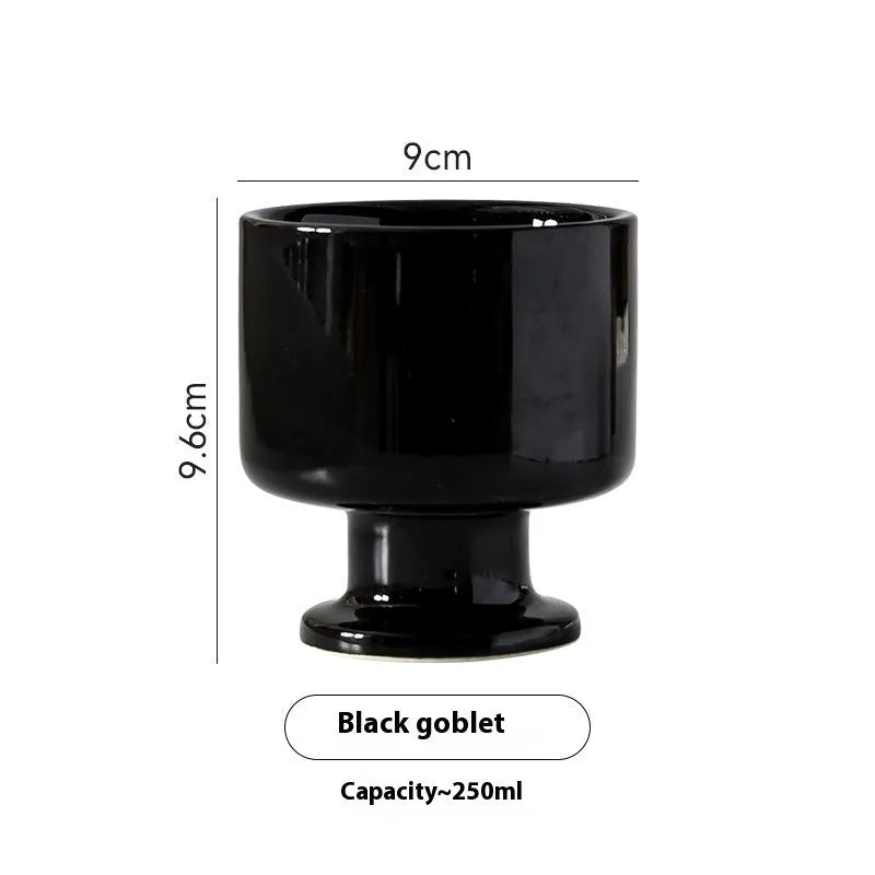 Hand-pinched irregular shaped solid colour ceramic mug on a table, showing its unique form and modern simplicity design.