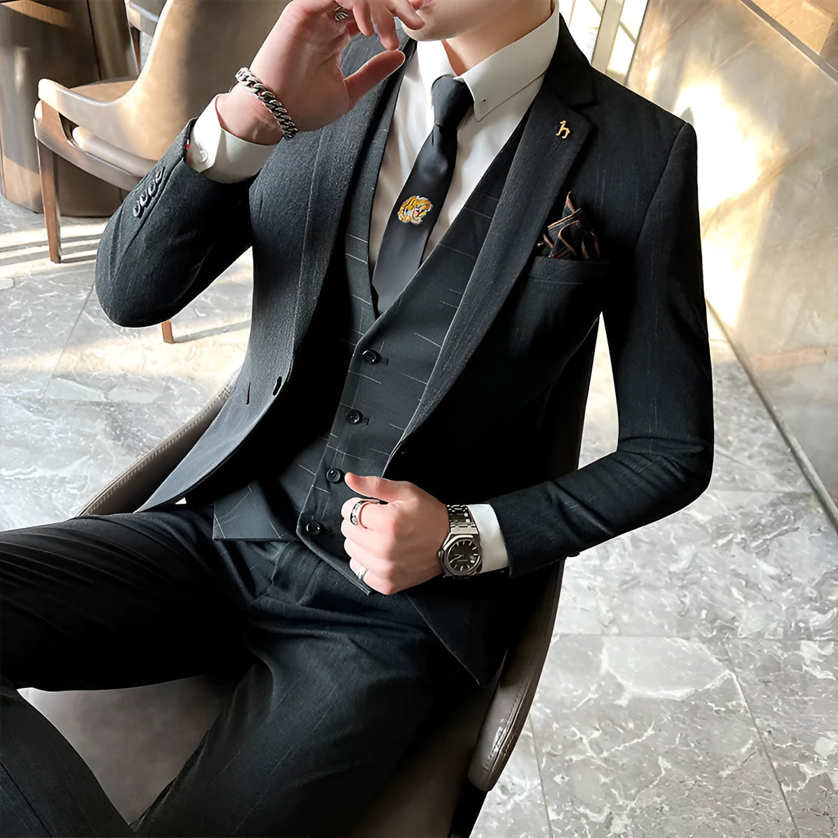 Men's slim fit black business suit jacket and trousers on a hanger.