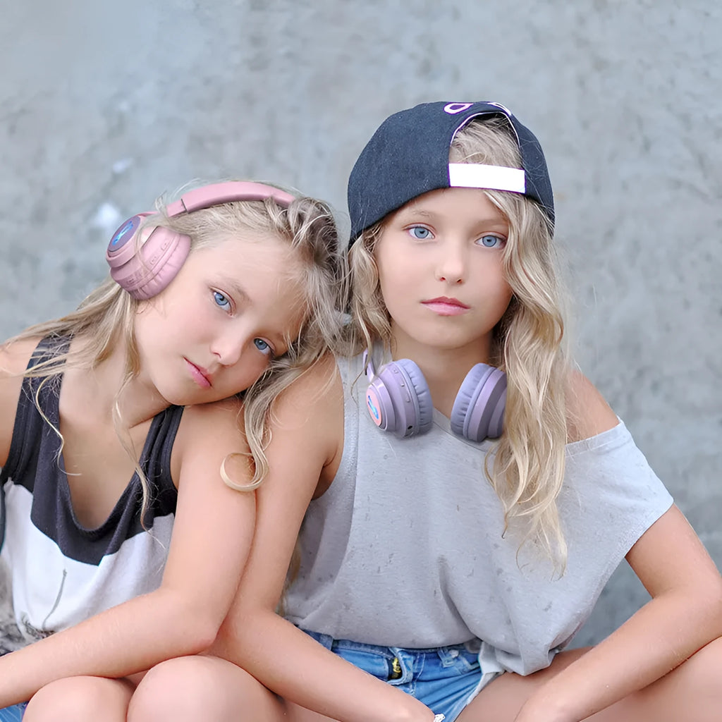 Wireless children's headphones with RGB LED lights in bunny pink colour showing power display