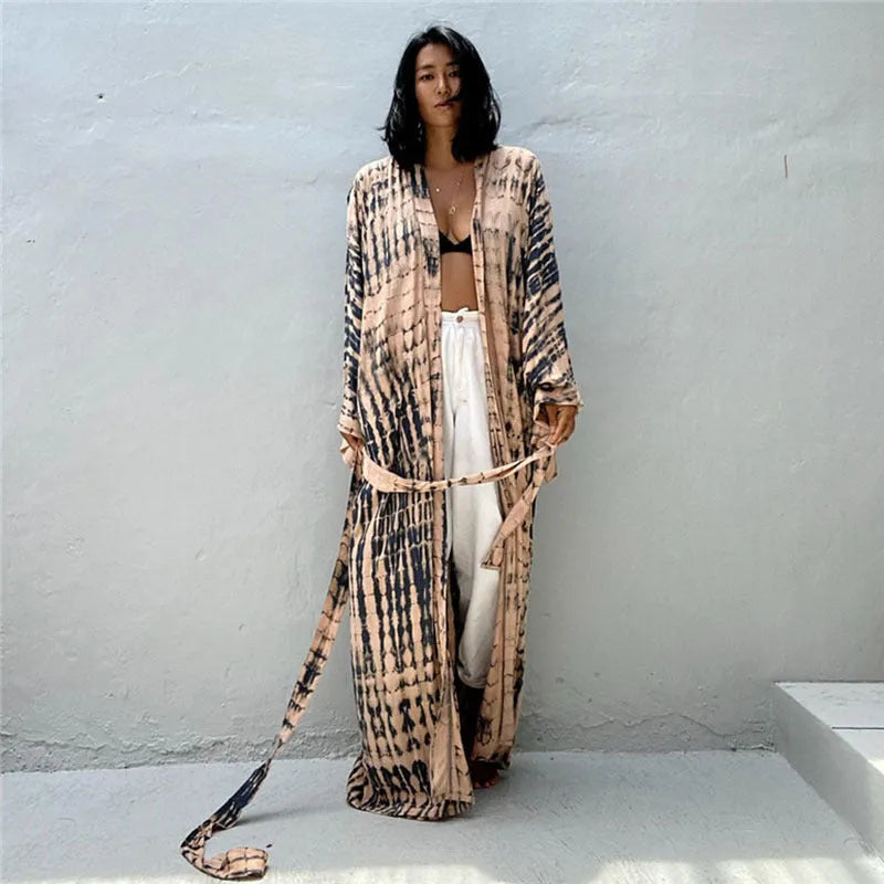 A printed, loose-fitting cotton beach cover-up blouse on a hanger, shown in a rust red colour from the DN0712 series.