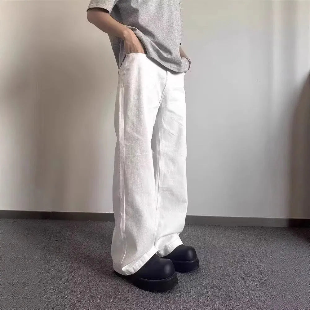 Men's white straight-leg wide-cut denim jeans on a plain background, showing front and side views.