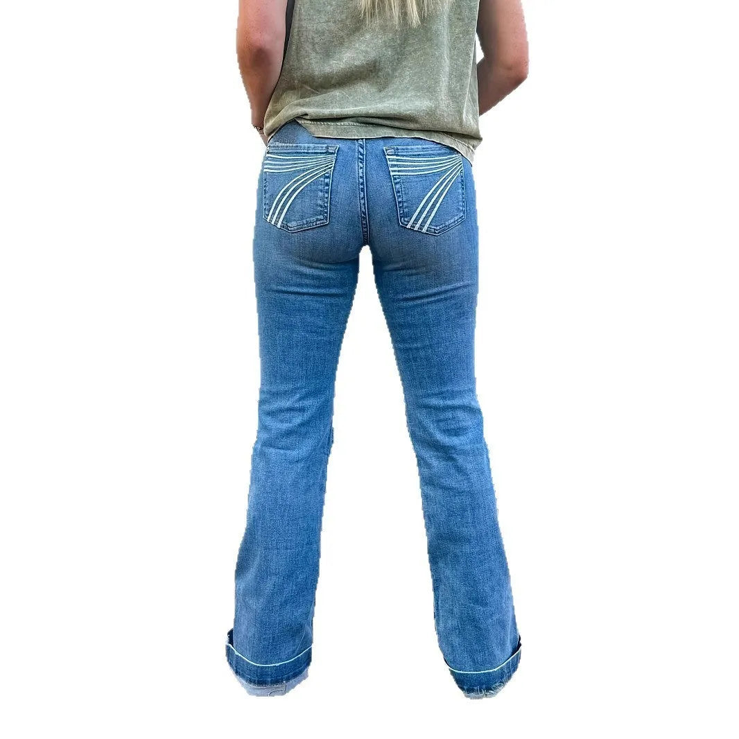 Women's slim fit mid-waist jeans with slight flare and embroidery detail on denim fabric