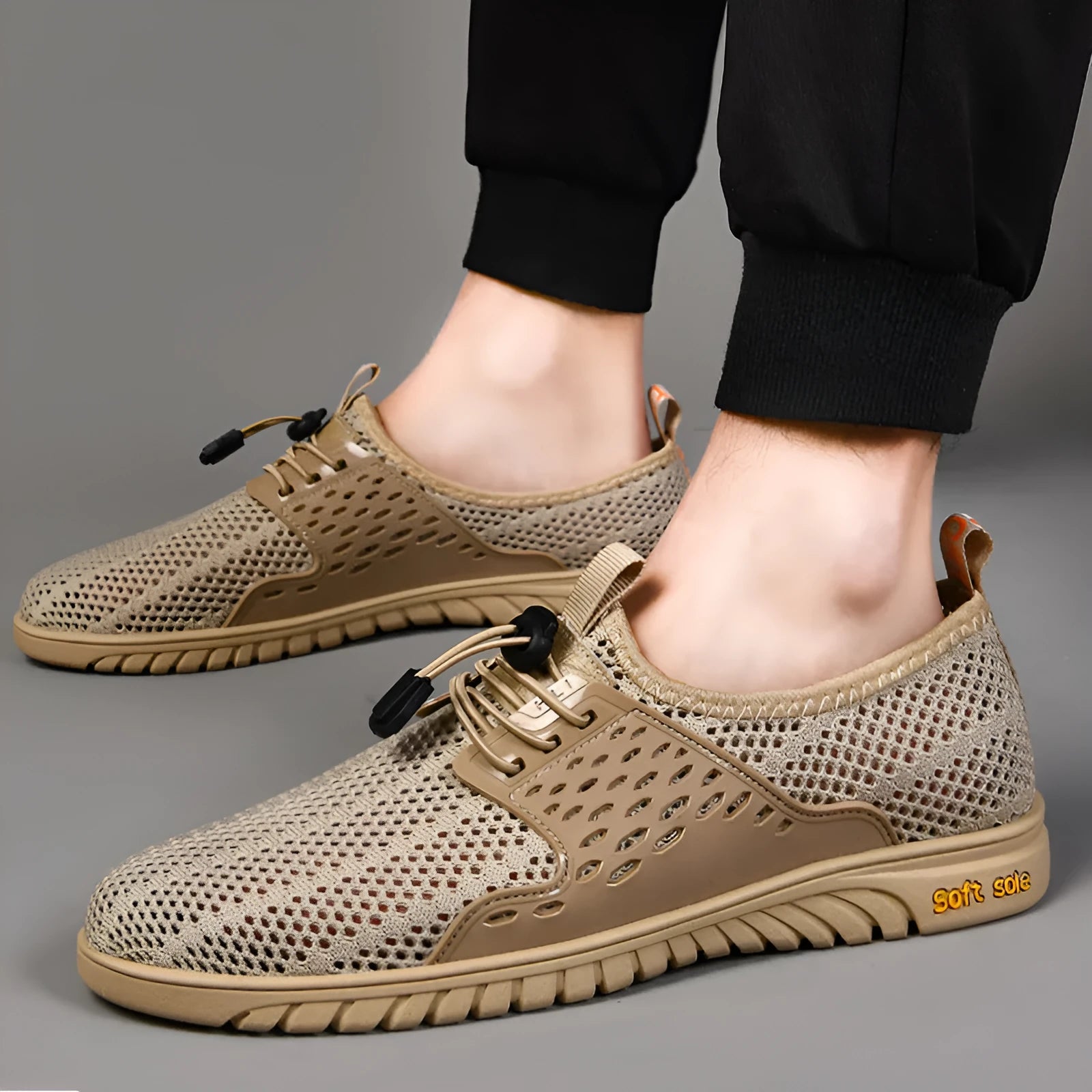 Men's casual shoes with mesh upper and elastic band in black, grey, or sand colour