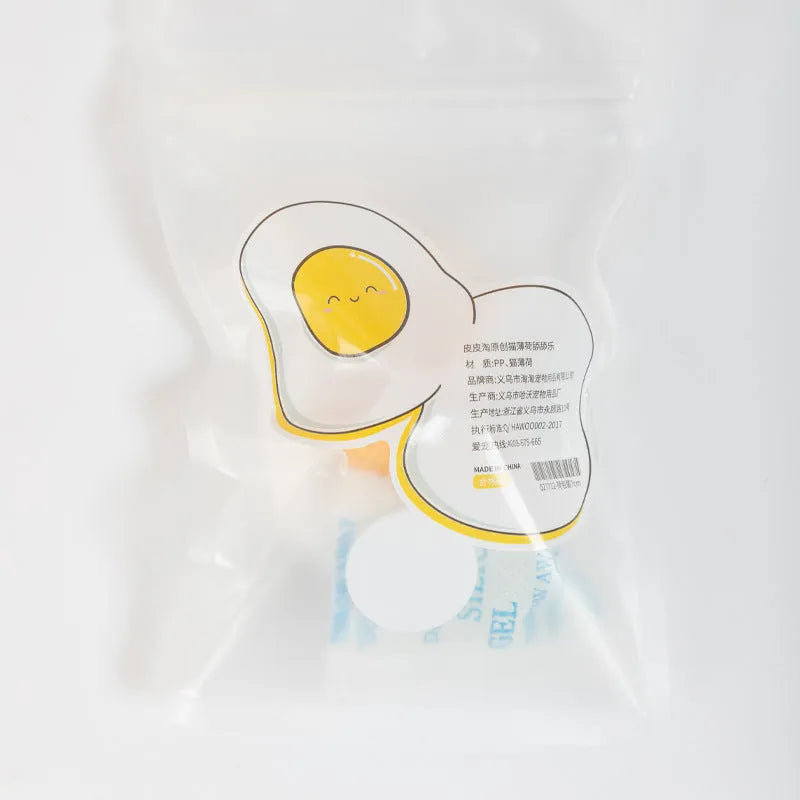 Catnip ball toy in fried egg and poached egg shapes with adhesive backing for wall and floor play