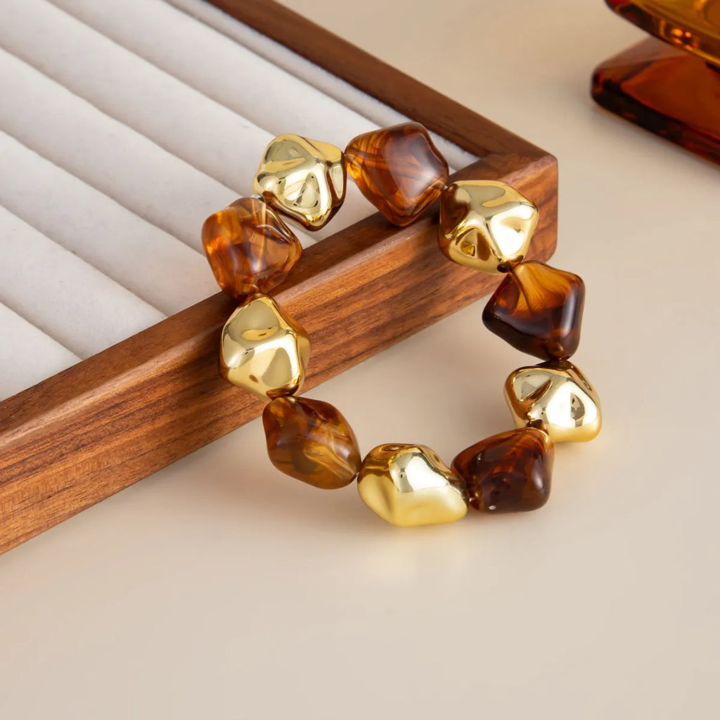 Vintage beaded amber blooming resin wide bracelet with electroplated alloy in gold or coffee colour.