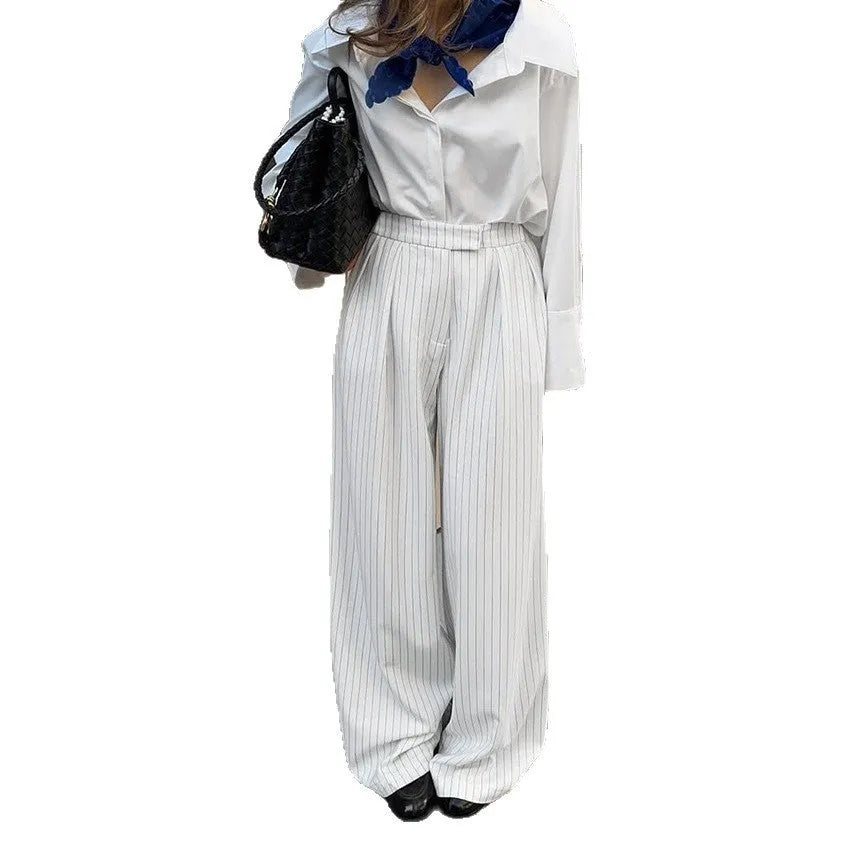 White striped wide-leg women's trousers with a front zip closure on a model