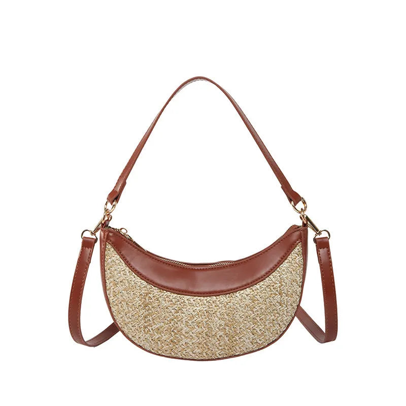 Hard straw women's crossbody dumpling bag in black with contrast stitching and single shoulder strap.