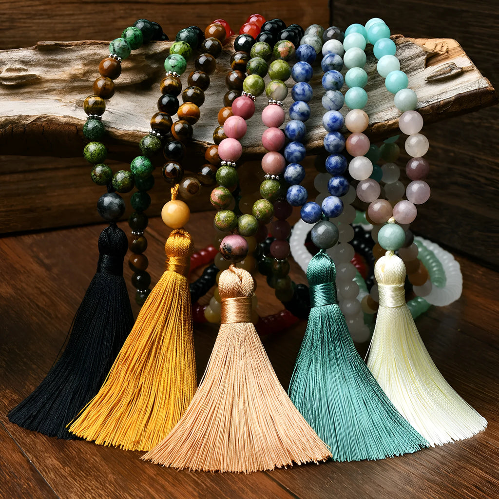 Long 108-bead natural stone necklace with colour-matched tassels and a geometric gem-inlaid pendant on a ball bead chain.
