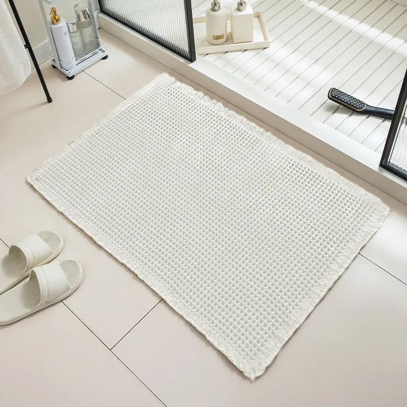 Checkered pattern non-slip absorbent bathroom carpet on a tiled floor.
